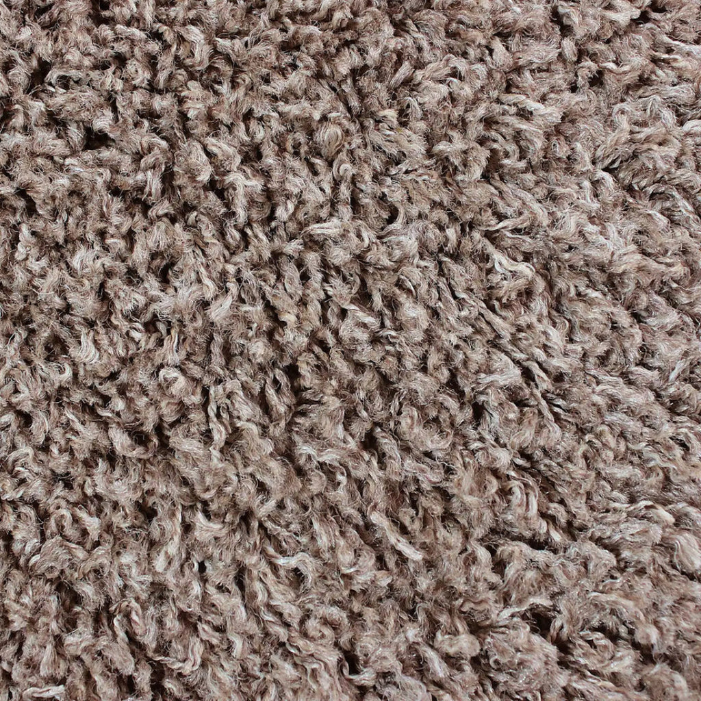 Close-up of a shaggy, curly carpet or rug texture in a warm taupe-brown color.