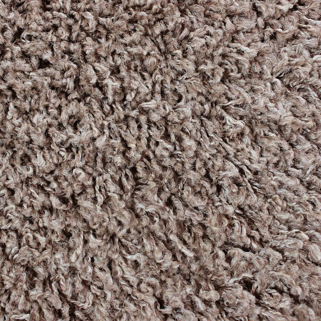 Close-up of a shaggy, curly carpet or rug texture in a warm taupe-brown color.