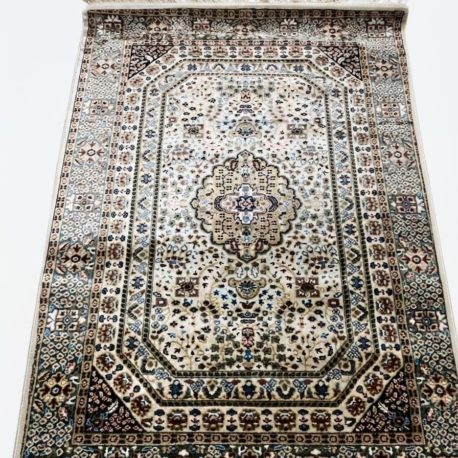 A traditional oriental-style area rug with an intricate floral and geometric pattern, featuring a central medallion, detailed borders, and cream-colored fringe on the top and bottom edges.