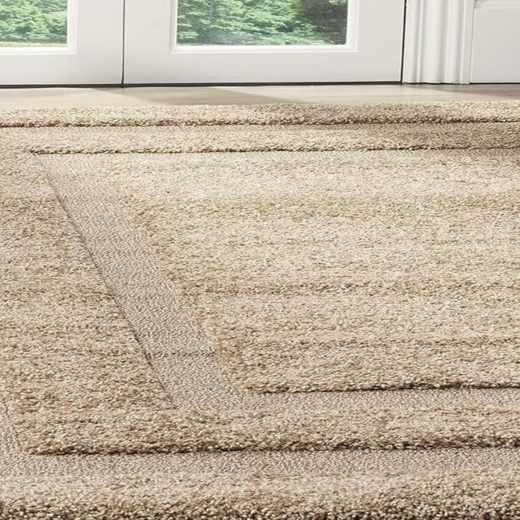 A close-up view of a shag area rug in a warm beige color, positioned on a light-colored floor in front of white glass doors.