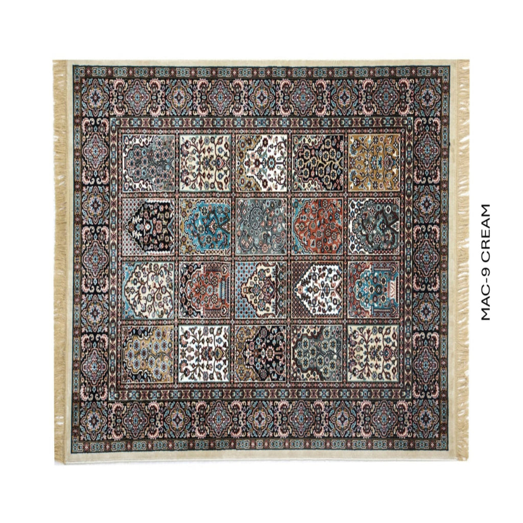 A rectangular patterned rug with cream fringe on all sides, shown flat against a white background. The rug features a complex traditional design with multiple panels in cream, blue, brown, and black.