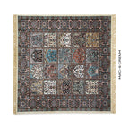 A rectangular patterned rug with cream fringe on all sides, shown flat against a white background. The rug features a complex traditional design with multiple panels in cream, blue, brown, and black.