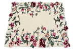 A square cream-colored area rug with a dense floral border pattern featuring pink, burgundy, and green flowers with small blue accents.